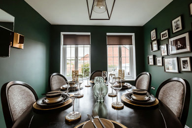 Photo of a small modern enclosed dining room in Other with green walls, carpet and beige floors.