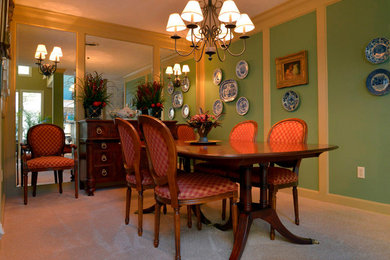 Example of a small classic carpeted dining room design in Other with green walls
