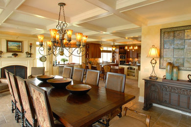 Large tuscan kitchen/dining room combo photo in New York with yellow walls, a standard fireplace and a plaster fireplace