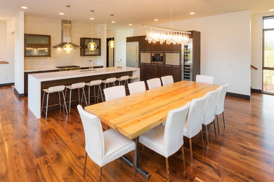 Example of a mid-sized transitional medium tone wood floor and brown floor dining room design in Denver with white walls and no fireplace