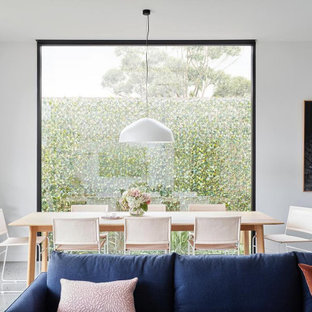 Design ideas for a modern dining room in Melbourne with white walls, concrete floors and grey floor.