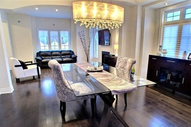 Example of a mid-sized trendy dark wood floor great room design in Toronto with white walls and a standard fireplace
