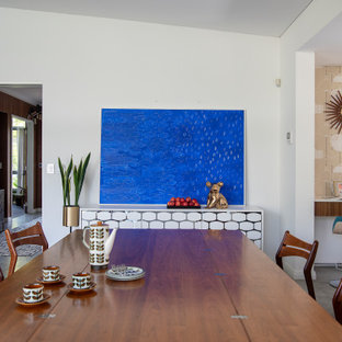 Midcentury open plan dining in Perth with white walls and grey floor.