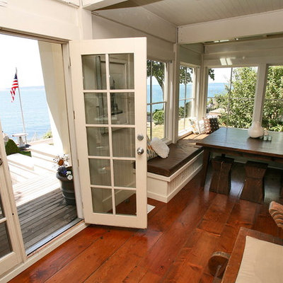 Example of a mid-sized beach style dark wood floor great room design in Seattle with white walls