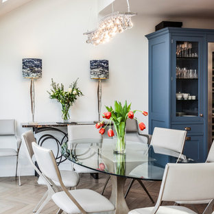 Medium sized contemporary dining room in London with white walls, light hardwood flooring and beige floors.
