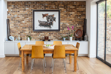 Medium sized contemporary dining room in London with light hardwood flooring and brown floors.