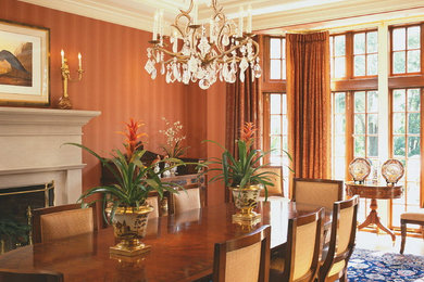 Medium sized classic enclosed dining room in New York with brown walls, a standard fireplace and a stone fireplace surround.