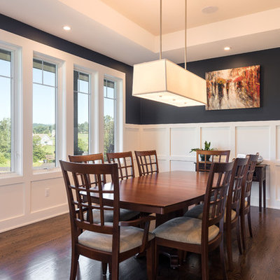 Inspiration for a mid-sized transitional dark wood floor and brown floor enclosed dining room remodel in Other with black walls