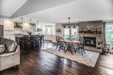 Great room - large transitional dark wood floor and brown floor great room idea in Other with gray walls, a standard fireplace and a brick fireplace