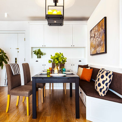 Transitional medium tone wood floor dining room photo in Hong Kong with white walls