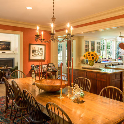 Elegant medium tone wood floor kitchen/dining room combo photo in Philadelphia with no fireplace and orange walls