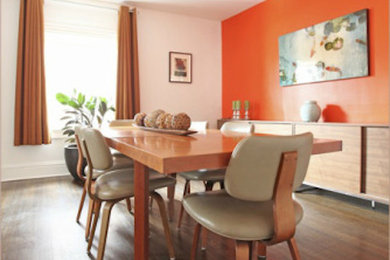 Inspiration for a large contemporary medium tone wood floor enclosed dining room remodel in Toronto with orange walls and no fireplace