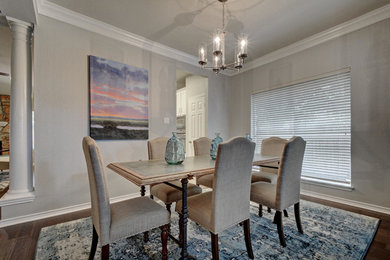 Example of a mid-sized transitional dark wood floor and brown floor dining room design in Austin with gray walls