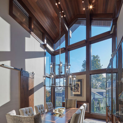 Enclosed dining room - rustic dark wood floor and brown floor enclosed dining room idea in Detroit with beige walls