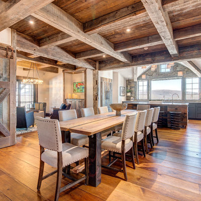 Mountain style medium tone wood floor kitchen/dining room combo photo in Boston with white walls