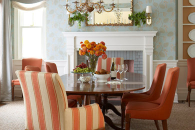 Inspiration for a timeless dining room remodel in New York with blue walls and a standard fireplace