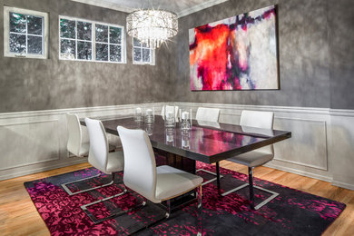 Photo of a small modern dining room in Seattle with grey walls, medium hardwood flooring and no fireplace.