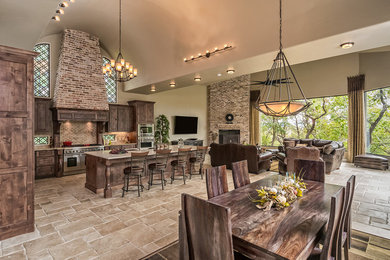 Kitchen/dining room combo - traditional travertine floor kitchen/dining room combo idea in Austin with beige walls