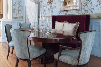 Elegant medium tone wood floor and brown floor enclosed dining room photo in San Francisco with blue walls