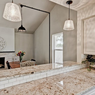 Kitchen/dining room combo - small industrial dark wood floor kitchen/dining room combo idea in Phoenix with gray walls, a standard fireplace and a stone fireplace