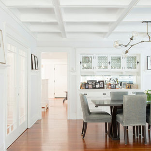 Example of a beach style dark wood floor dining room design in Los Angeles with white walls