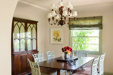 Example of a large tuscan dark wood floor enclosed dining room design in Los Angeles with white walls
