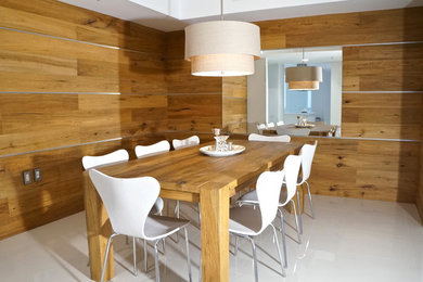 Trendy ceramic tile kitchen/dining room combo photo in Miami with brown walls