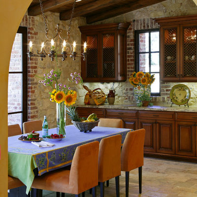 Example of a mid-sized tuscan limestone floor and beige floor kitchen/dining room combo design in Orange County with no fireplace and beige walls