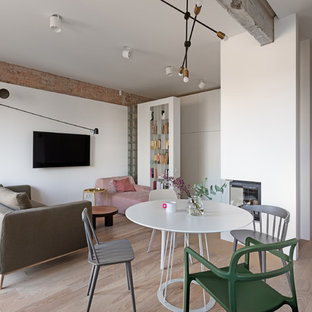 Scandi open plan dining room in Dorset with white walls, light hardwood flooring and beige floors.