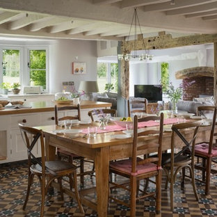 Photo of a medium sized farmhouse open plan dining room in Cheshire with grey walls, ceramic flooring and beige floors.