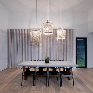 Design ideas for a beach style dining room in Gold Coast - Tweed with white walls, medium hardwood floors and brown floor.