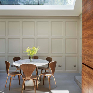This is an example of a medium sized contemporary kitchen/dining room in London with beige walls, porcelain flooring and grey floors.