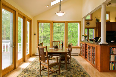 Example of a mid-sized transitional medium tone wood floor kitchen/dining room combo design in New York with yellow walls