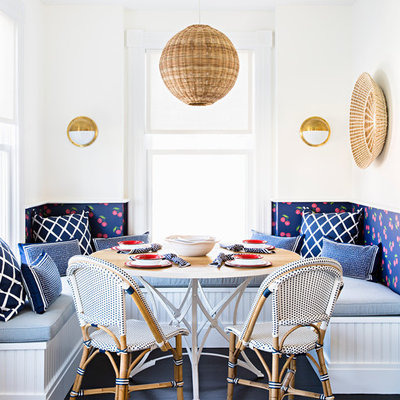Example of a mid-sized beach style dark wood floor and brown floor kitchen/dining room combo design in New York with white walls and no fireplace