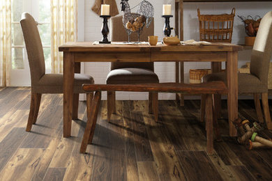 Example of a mid-sized transitional medium tone wood floor great room design in Other with white walls and no fireplace