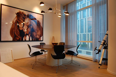 Example of a minimalist light wood floor dining room design in New York with beige walls