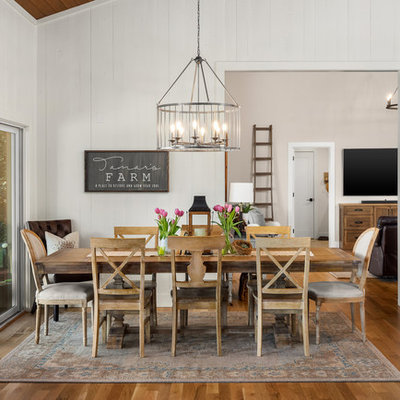 Inspiration for a country medium tone wood floor and brown floor dining room remodel in Portland with white walls