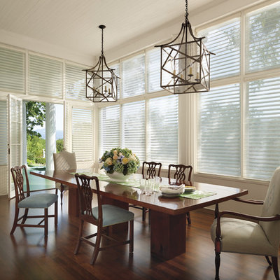 Inspiration for a large transitional dark wood floor and brown floor great room remodel in New York with beige walls and no fireplace