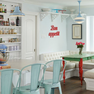 Example of a cottage chic dark wood floor and brown floor enclosed dining room design in Houston with blue walls