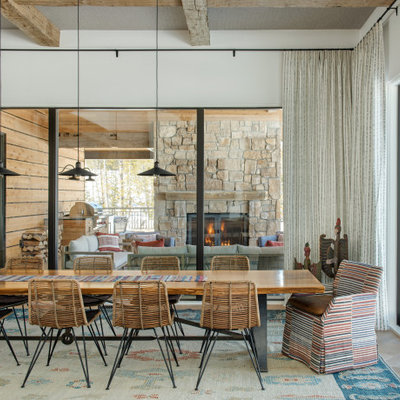 Mountain style medium tone wood floor and brown floor dining room photo in Other with white walls