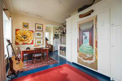 Example of a beach style painted wood floor and blue floor dining room design in Other
