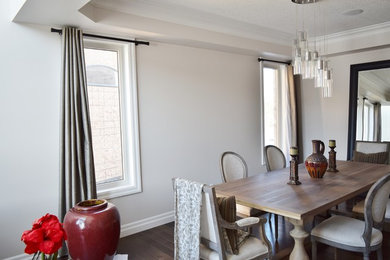 Medium sized classic open plan dining room in Toronto with dark hardwood flooring, white walls, no fireplace and brown floors.