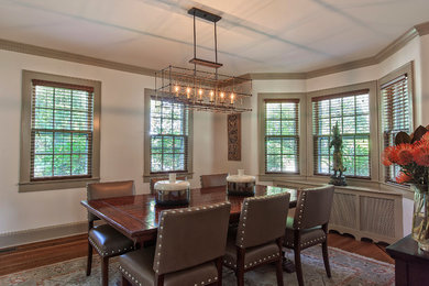 Example of a mid-sized transitional light wood floor dining room design in New York with beige walls