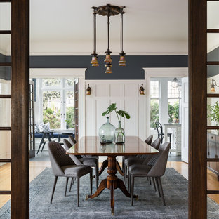 Example of a mid-sized arts and crafts medium tone wood floor and beige floor enclosed dining room design in Seattle with multicolored walls and no fireplace