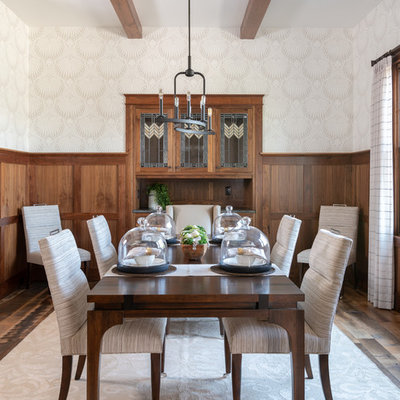 Example of a transitional medium tone wood floor and brown floor enclosed dining room design in Dallas with white walls