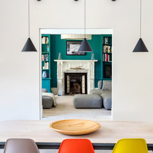 Inspiration for a medium sized contemporary enclosed dining room in London with white walls, light hardwood flooring and beige floors.