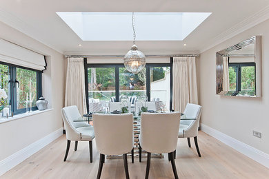 Inspiration for a traditional dining room in Surrey with light hardwood flooring and no fireplace.