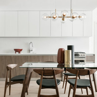 Example of a mid-sized 1950s light wood floor and beige floor kitchen/dining room combo design in New York with white walls