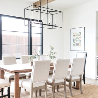 Example of a tuscan medium tone wood floor and brown floor dining room design in Los Angeles with white walls