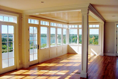 Inspiration for a mid-sized contemporary medium tone wood floor dining room remodel in Portland Maine with beige walls